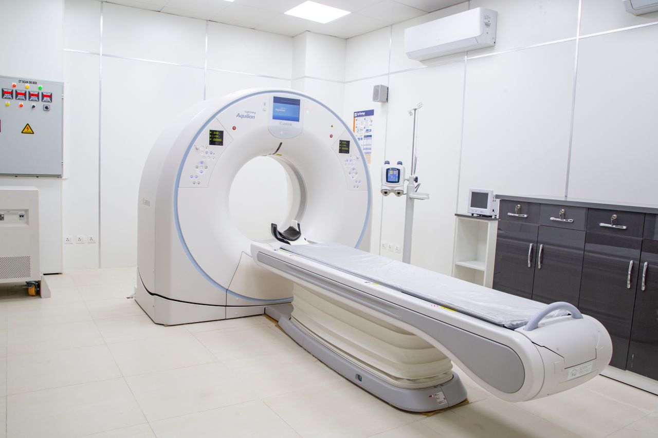 High-resolution image of a modern, clean MRI scanner room in a hospital facility.